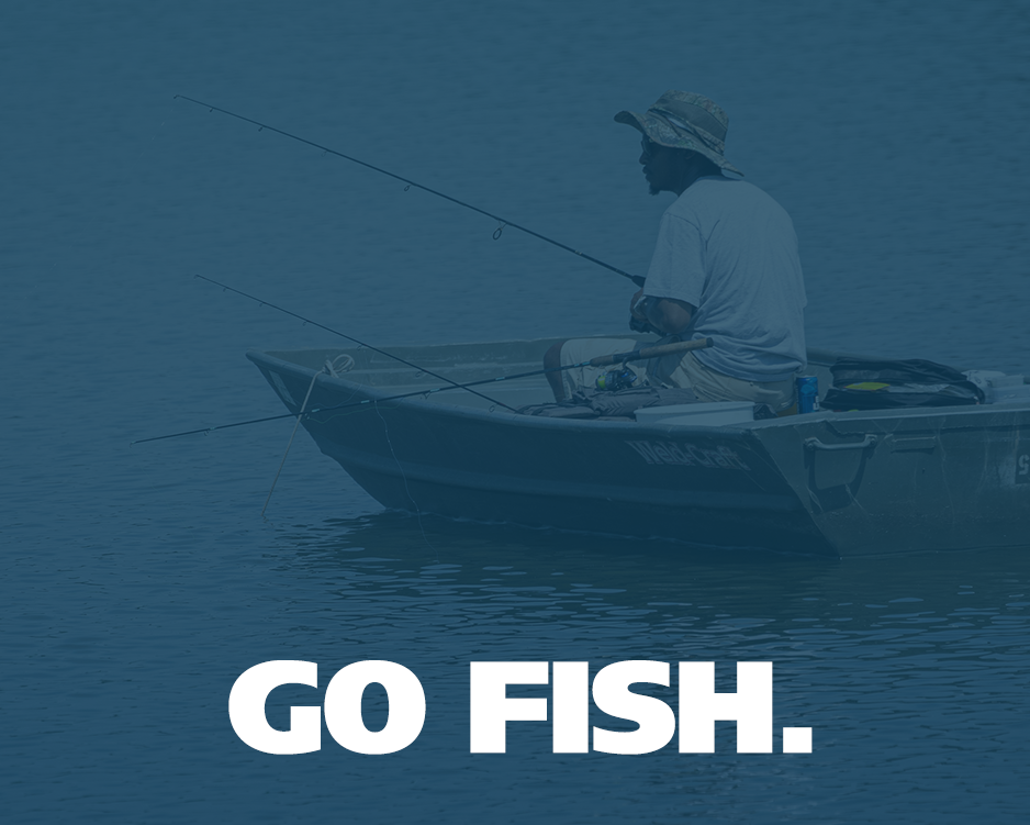 Fisherman reeling in a fish from a boat.